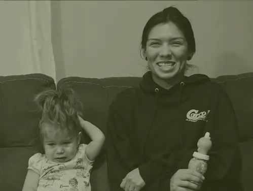 A woman sitting on a couch with a small child