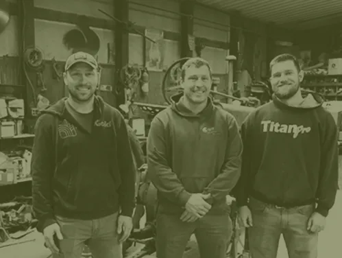 Three brothers standing together, smiling