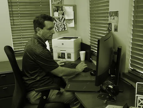 A man sitting at his desk on the computer