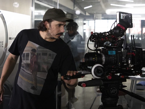 Closeup view of a camera operator and other crew members
