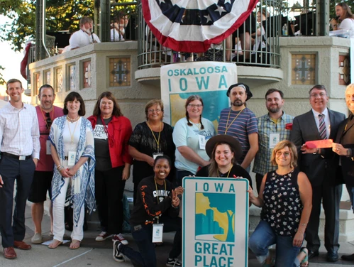 People holding an Iowa Great Place sign