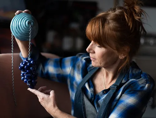 Glass artist holding her work