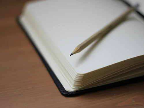 Close up of book and pencil