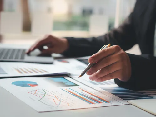 Person reviewing charts and graphs
