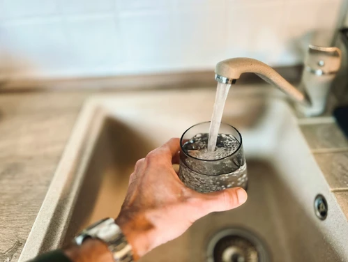 Filling glass with tap water