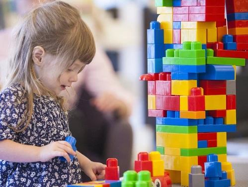 Young girl playing with building blocks