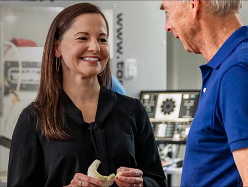 Two people standing in a laboratory space