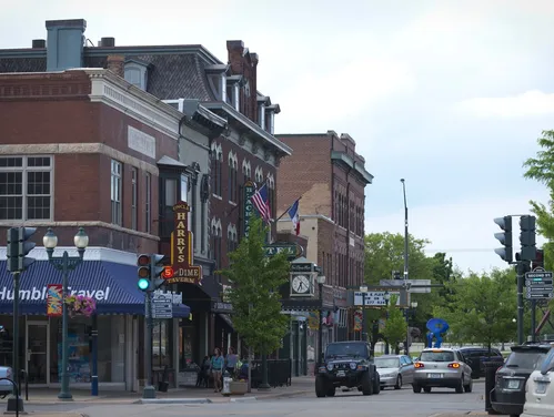 Main street with cars, shops and theater marquee