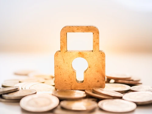 Coins surrounding a highlighted lock and keyhole 