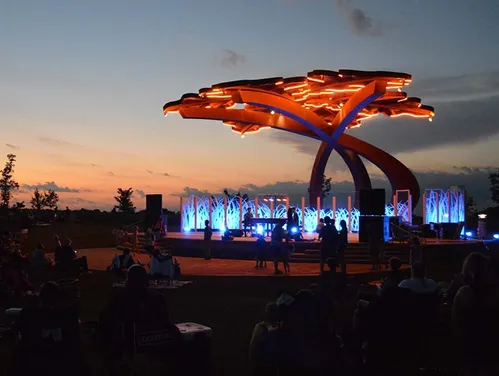 Outdoor music festival with sculpture
