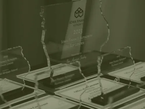 IFA Top Lender plaques and certificates/awards on desk