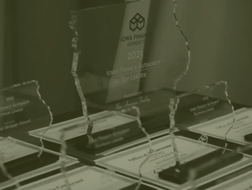 IFA Top Lender plaques and certificates/awards on desk