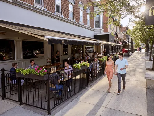 a couple walking outside of a restaurant patio