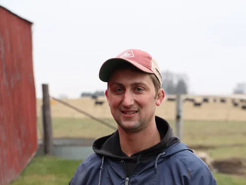 farmer standing near a barn
