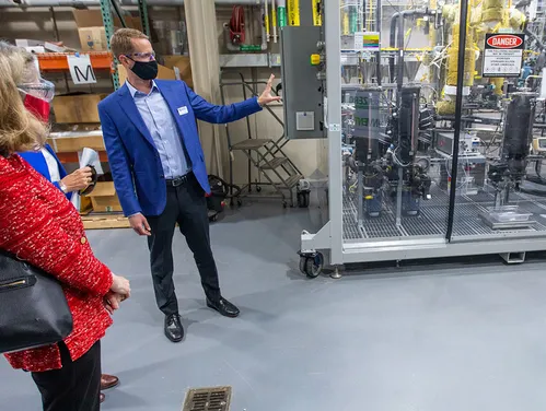 Man wearing mask showing off technology at Intellisee