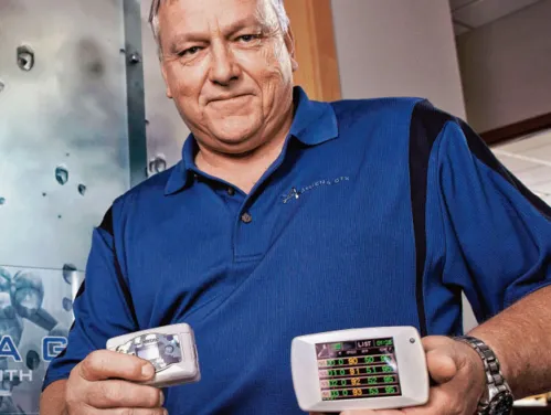 Mark Darrah, CEO holding devices made by his company, Athena GTX