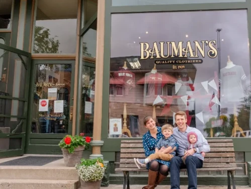 Portrait of the entire Randall family in front of the Bauman's building on the left