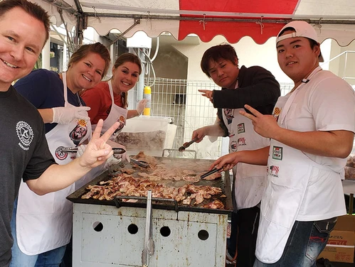 Nick Jones, CEO of Berkwood Farms with Japanese partners next to a grill
