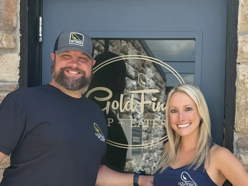 Owners of the GoldFinch Tap standing in front of their business' door