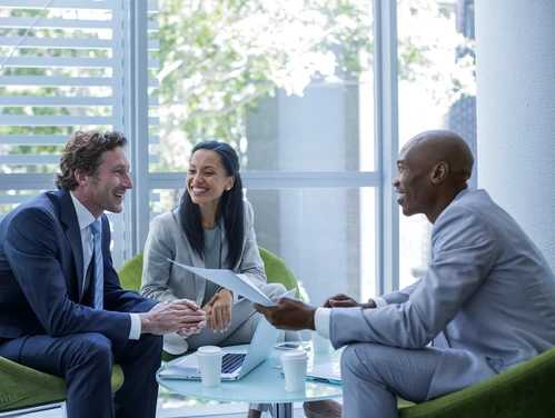 three people at an office working together at a table