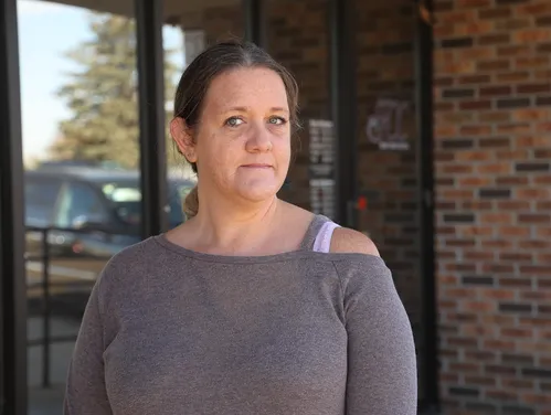 A woman standing outside of a crisis center