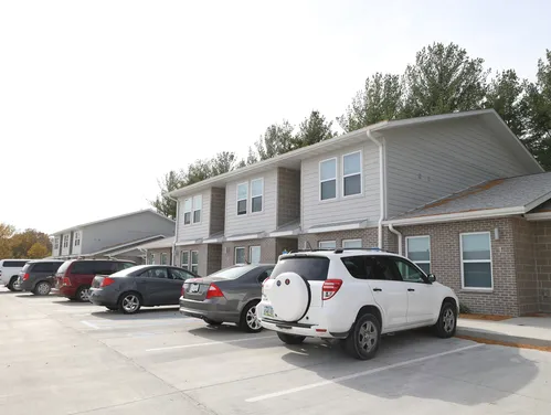 Townhome style housing with cars parked in front