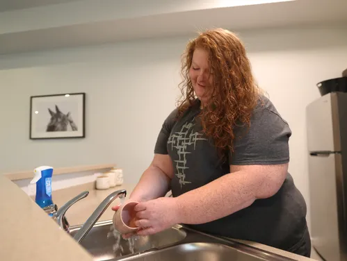 Woman washing dishes at a sink