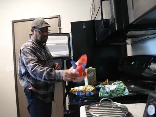 A man in a hat cooking a meal
