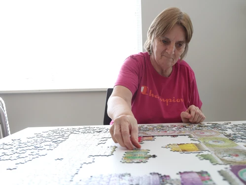 A woman working on a jigsaw puzzle
