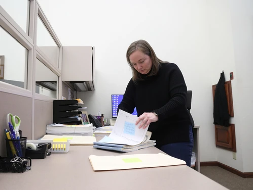 Woman going through real estate documents at a desk