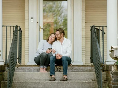 Couple sitting on the porch of a home