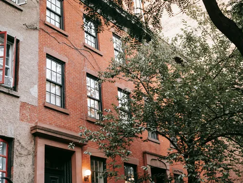 Exterior of an apartment building with a tree