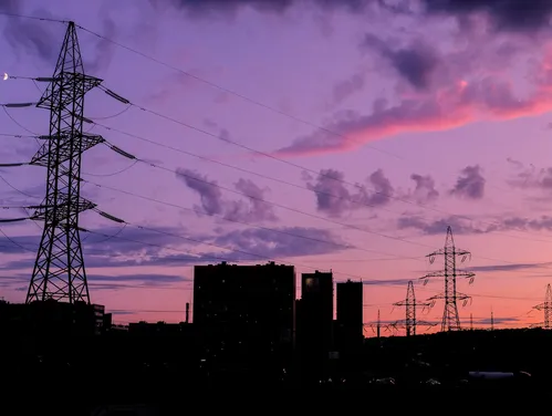 silhouette of buildings under cloudy sky during sunset