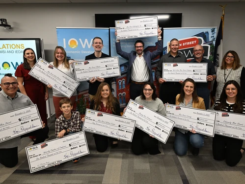 award recipients holding giant checks