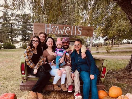 Family sitting on haystack