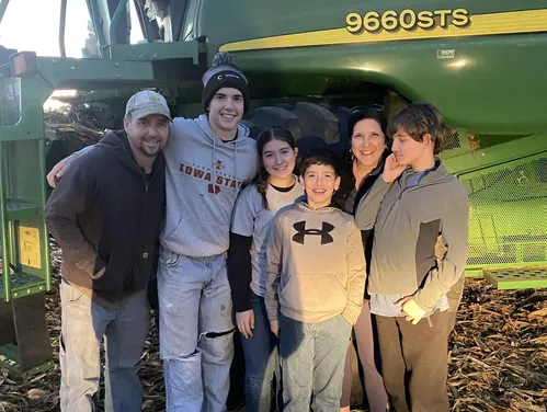 Family in front of tractor.