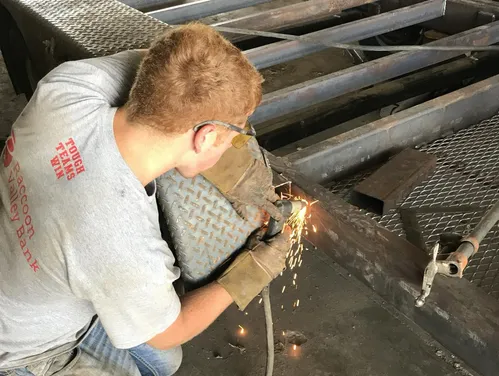 Farmer doing welding on equipment.