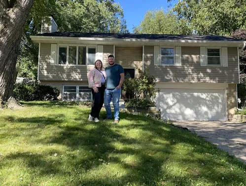 Couple standing in front of house