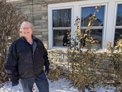 Woman standing in front of newly installed windows.