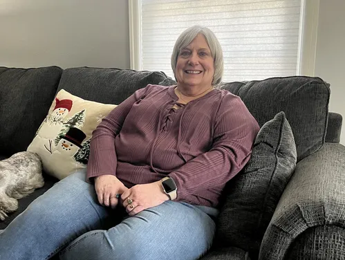 Woman sitting on couch.
