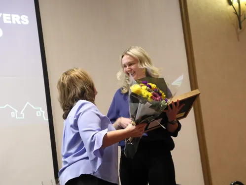 Presenting award and flowers to recepient