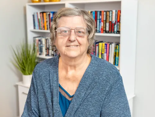 Woman in cardigan, headshot photo.