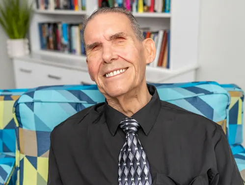 Headshot of man in dress shirt and tie.