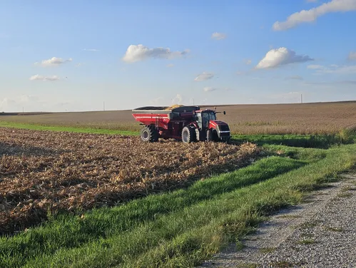 Red tractor on farm field.