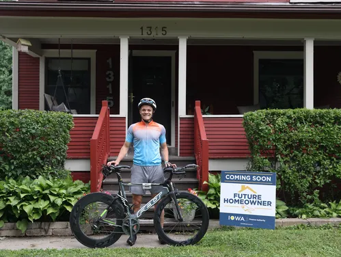 man on bike in front of house