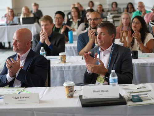 Judges and audience clapping after pitch competition