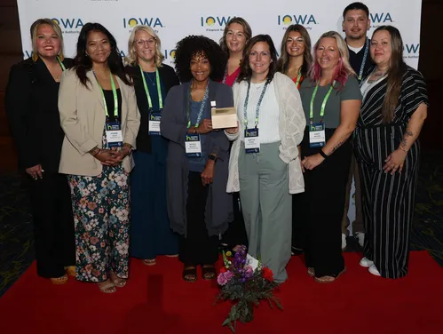 New Visions team posing with an award