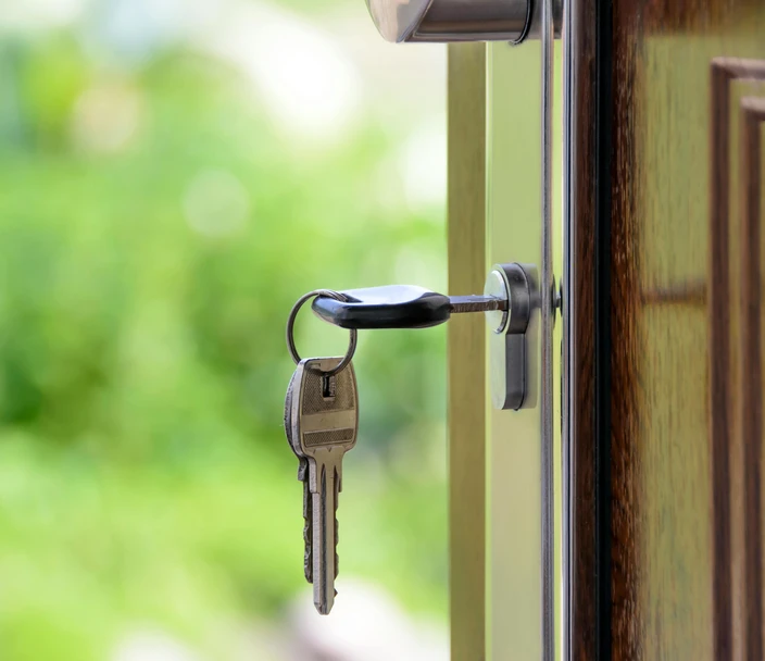 A key in a lock on a wooden door