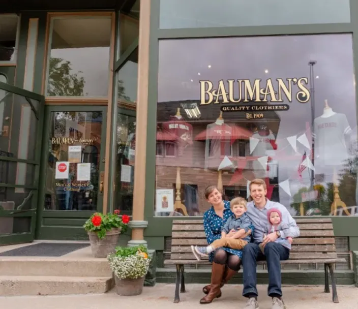 Portrait of the entire Randall family in front of the Bauman's building on the left