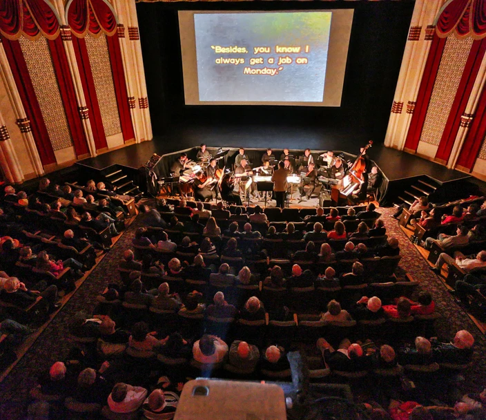 Theater full of people watching a movie